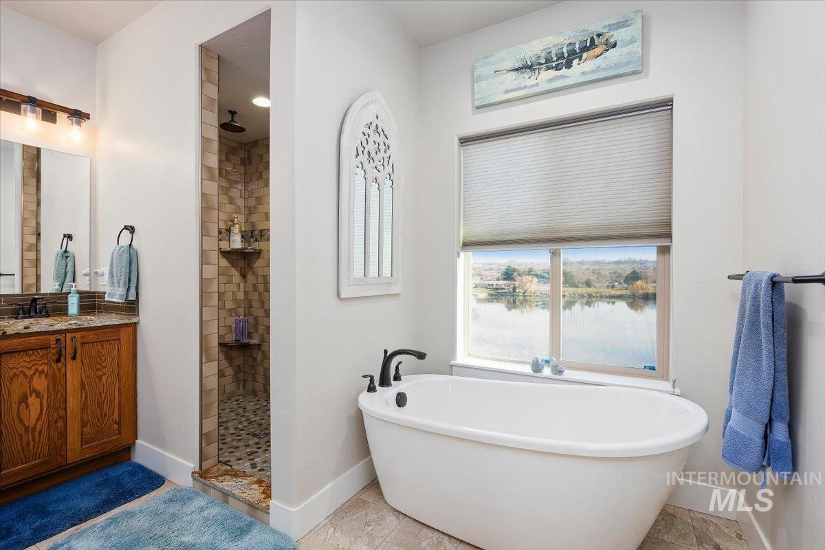 40 Bell Rapids Road Hagerman, ID 83332 - Photo 22 of 50 Full bath with a walk in shower, a freestanding bath, and vanity