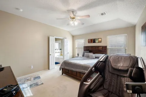 a bedroom with a bed and a couch