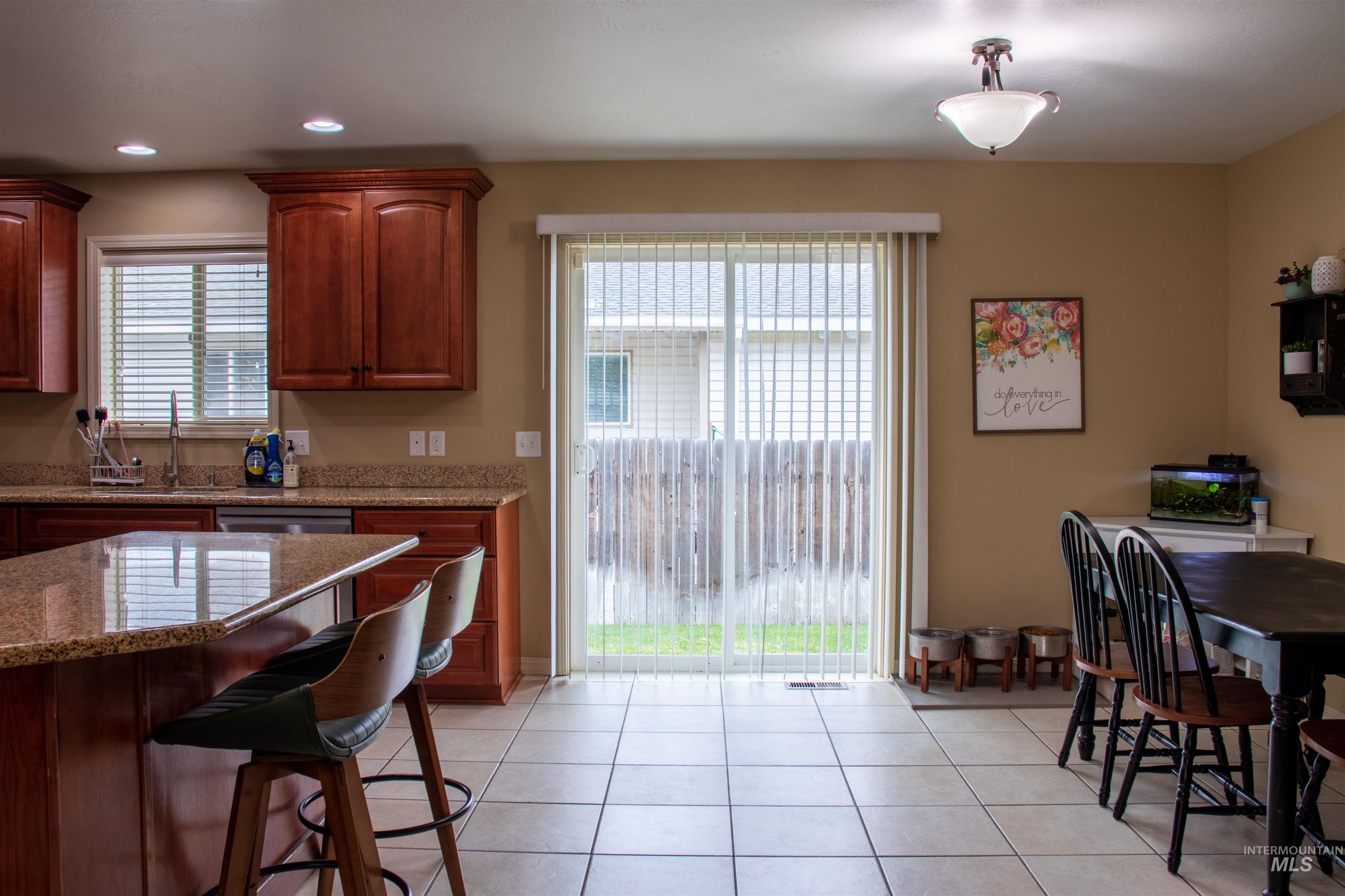 2000 M Street Heyburn, ID 83336 - Photo 3 of 15 Kitchen featuring rich wood cabinetry, stone countertops, and tile flooring