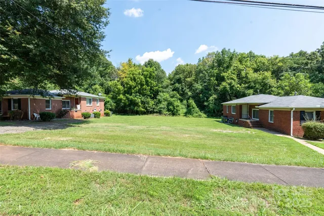 a front view of house with yard and trees