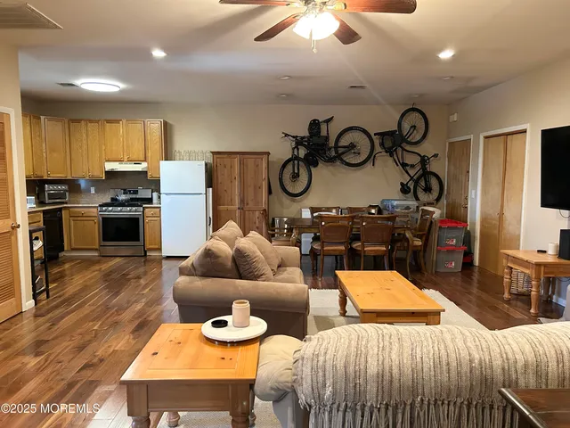 a kitchen with stainless steel appliances kitchen island granite countertop a table and chairs in it