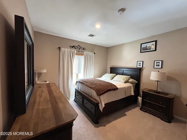 a bedroom with a bed and a night stand