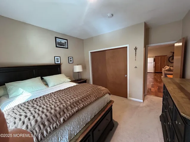 a bedroom with a bed and a dresser