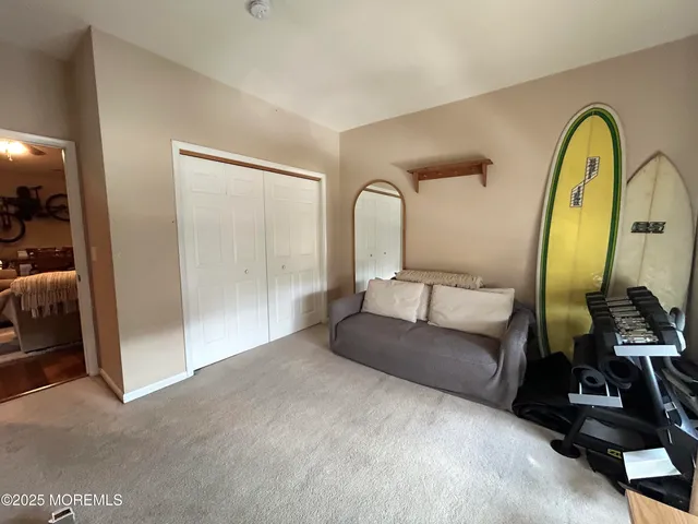 a spacious bedroom with a bed and a mirror