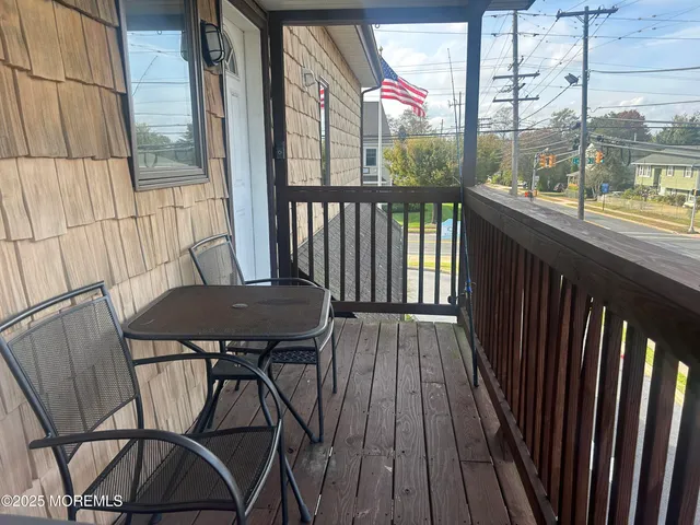 a view of a balcony with furniture
