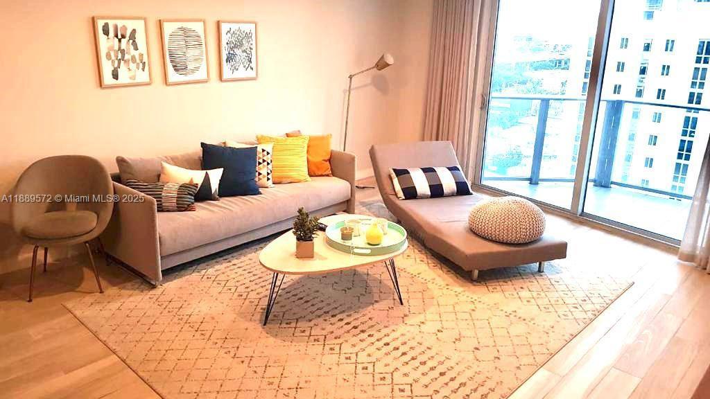 1010 Southwest 2nd Avenue, Unit 1105 Miami, FL 33130 - Photo 22 of 25 a living room with furniture a window and a table