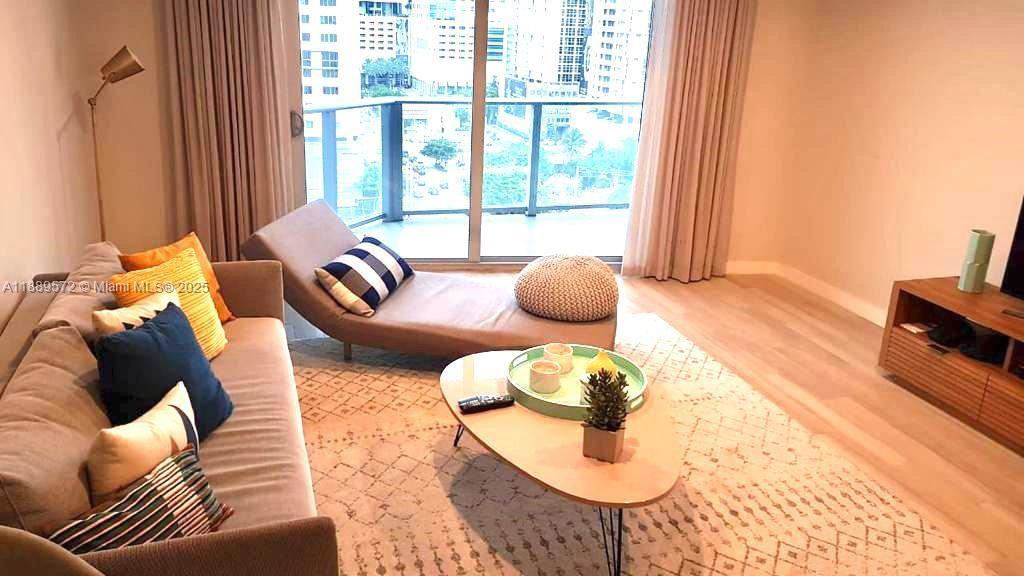 1010 Southwest 2nd Avenue, Unit 1105 Miami, FL 33130 - Photo 23 of 25 a living room with furniture and a large window