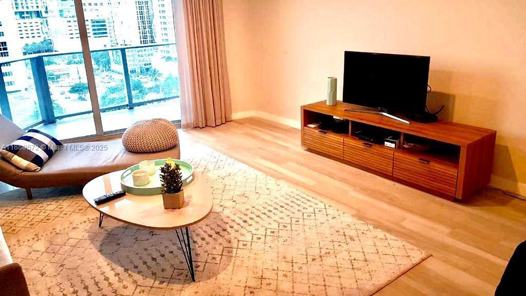 1010 Southwest 2nd Avenue, Unit 1105 Miami, FL 33130 - Photo 24 of 25 a living room with furniture and a flat screen tv