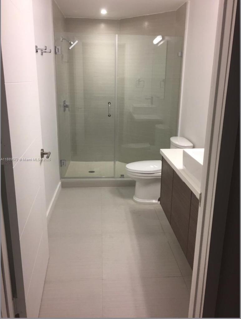 1010 Southwest 2nd Avenue, Unit 1105 Miami, FL 33130 - Photo 25 of 25 a bathroom with a sink a toilet and shower
