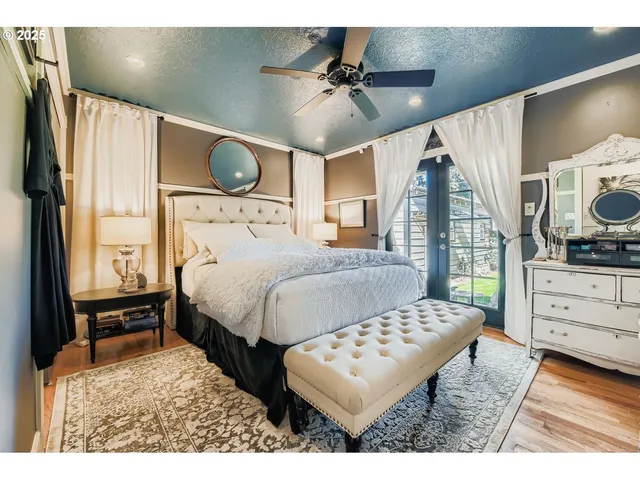 a bedroom with a bed window and a dresser