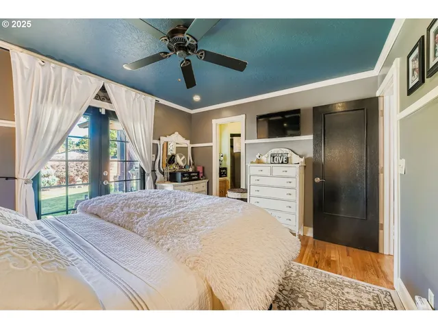 a bedroom with a bed and a large window with outer view