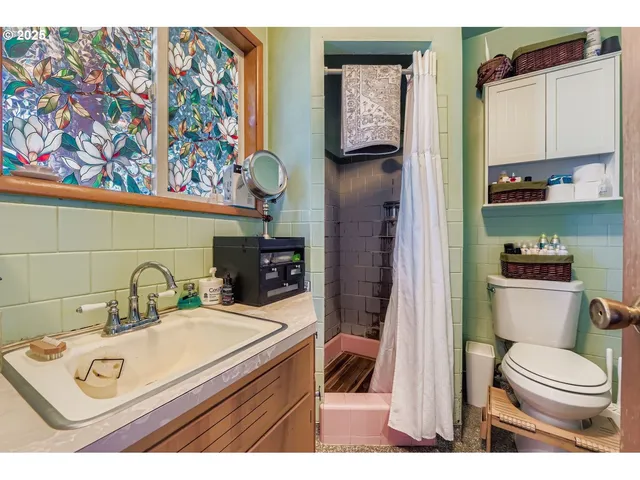 a bathroom with a toilet a sink and mirror