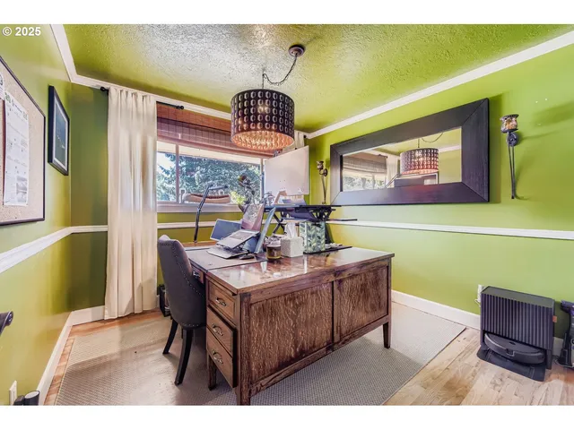 a view of a dining room with furniture and a chandelier