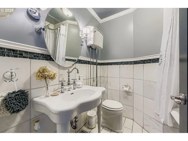 a bathroom with a sink mirror and toilet