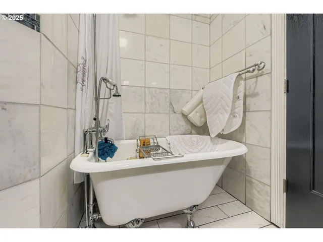 a bath tub sitting next to a white sink