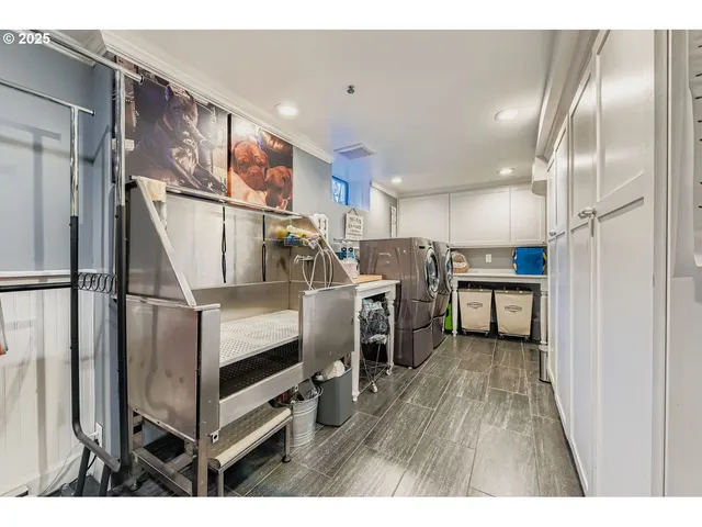 a kitchen with stainless steel appliances refrigerator wooden floor and window