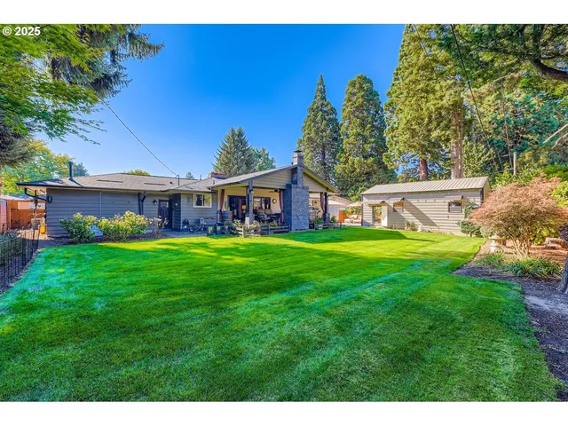 a view of a house with a yard table and chairs