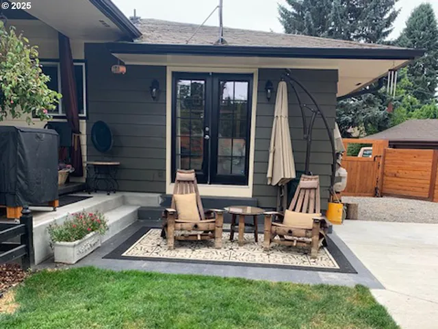 a view of backyard of house with outdoor seating