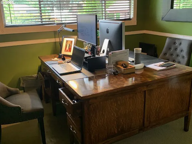 a dining room with furniture and a window