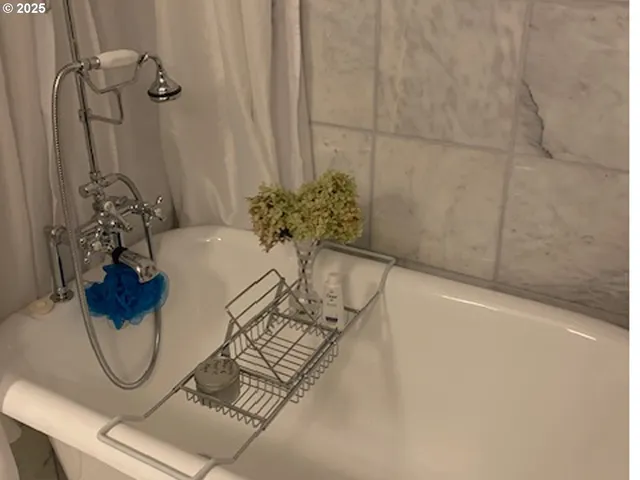 a bath tub sitting next to a white sink