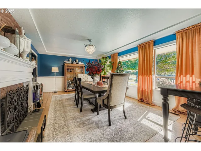 a dining room with furniture and a floor to ceiling window