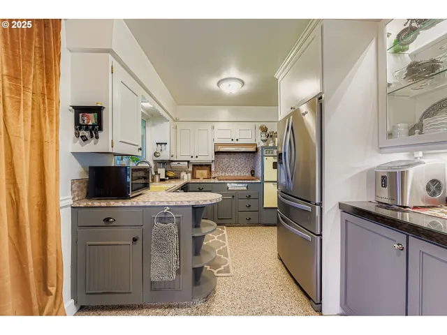 a kitchen with kitchen island a sink stove and refrigerator