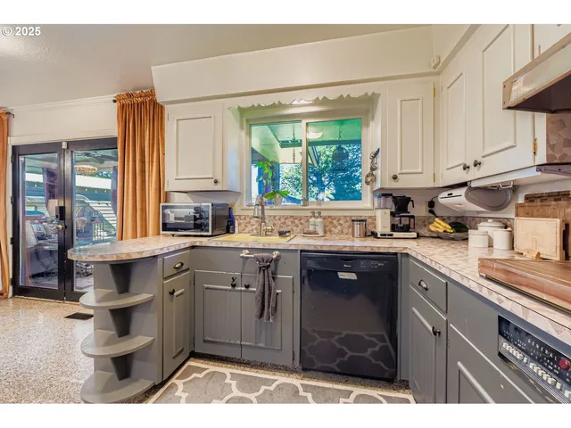 a kitchen with a sink cabinets and window