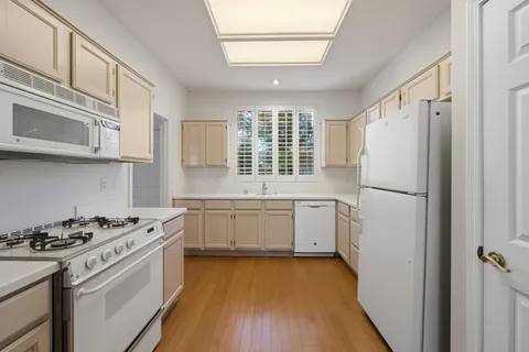 a kitchen with a white cabinets and white appliances