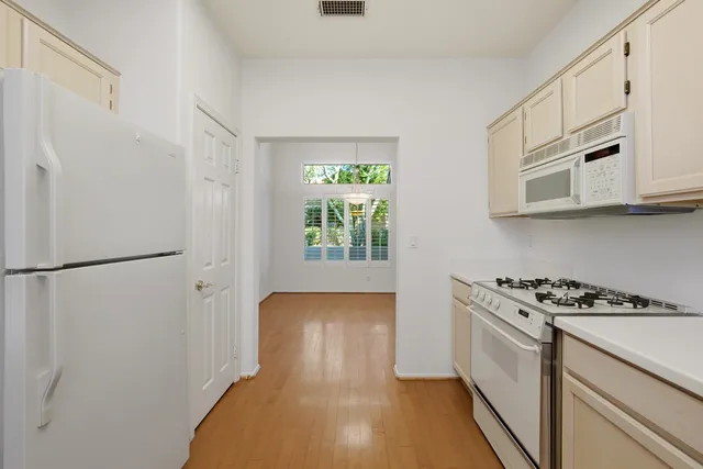 a kitchen with stainless steel appliances a refrigerator a stove a microwave and cabinets