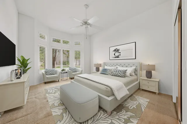 a spacious bedroom with a bed a couch and a potted plant