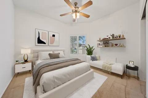 a bedroom with a bed and ceiling fan