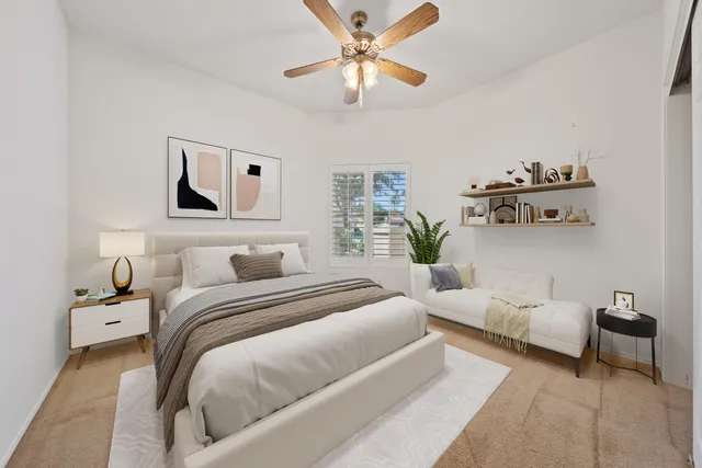 a bedroom with a bed and ceiling fan