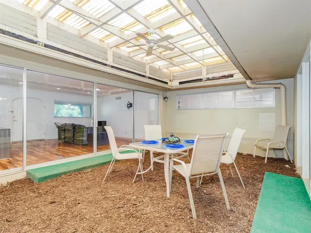 a dining room with a wooden table and chairs