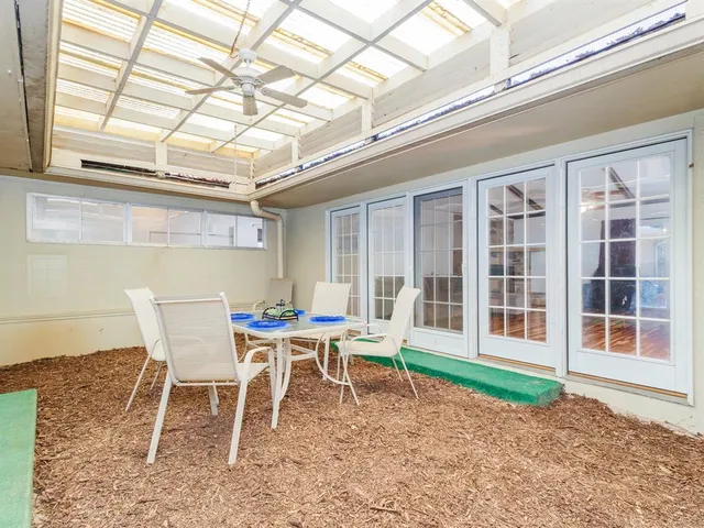 a dining room with a wooden table and chairs
