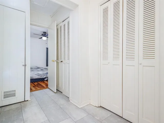a bedroom with furniture and a ceiling fan