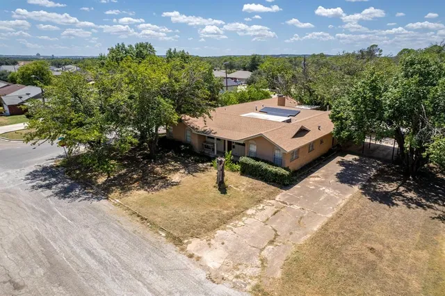 a view of a backyard with large trees
