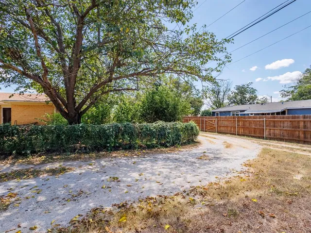 a backyard of a house with barbeque oven