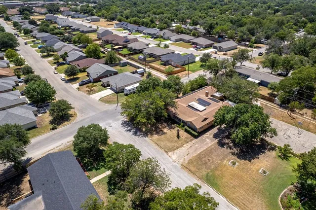 an aerial view of residential houses with outdoor space