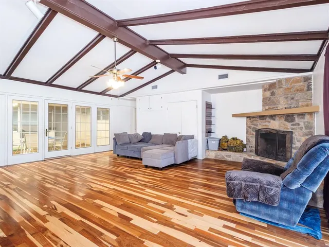 a living room with furniture a fireplace and a table