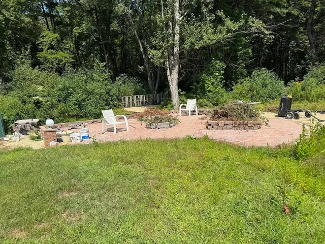 a view of a backyard with a sitting area