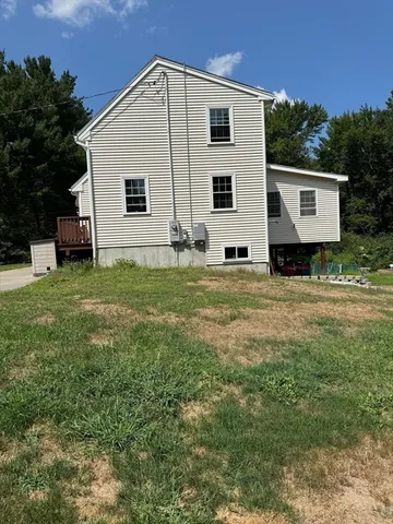 a view of a house with a backyard