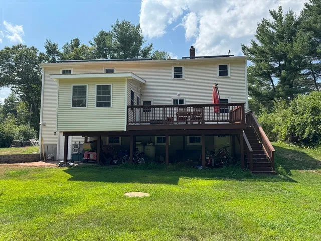 a view of a house with backyard and sitting area