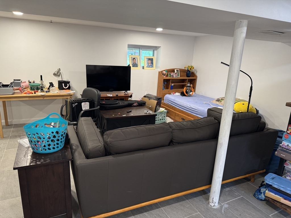 8 Heritage Road, Unit 1 Pelham, NH 03076 - Photo 9 of 13 a living room with furniture and a flat screen tv