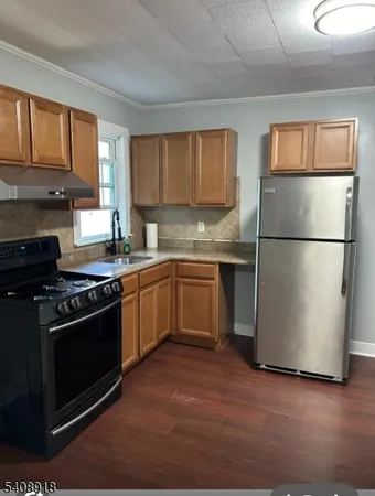 a kitchen with a stove a sink dishwasher a refrigerator and a microwave