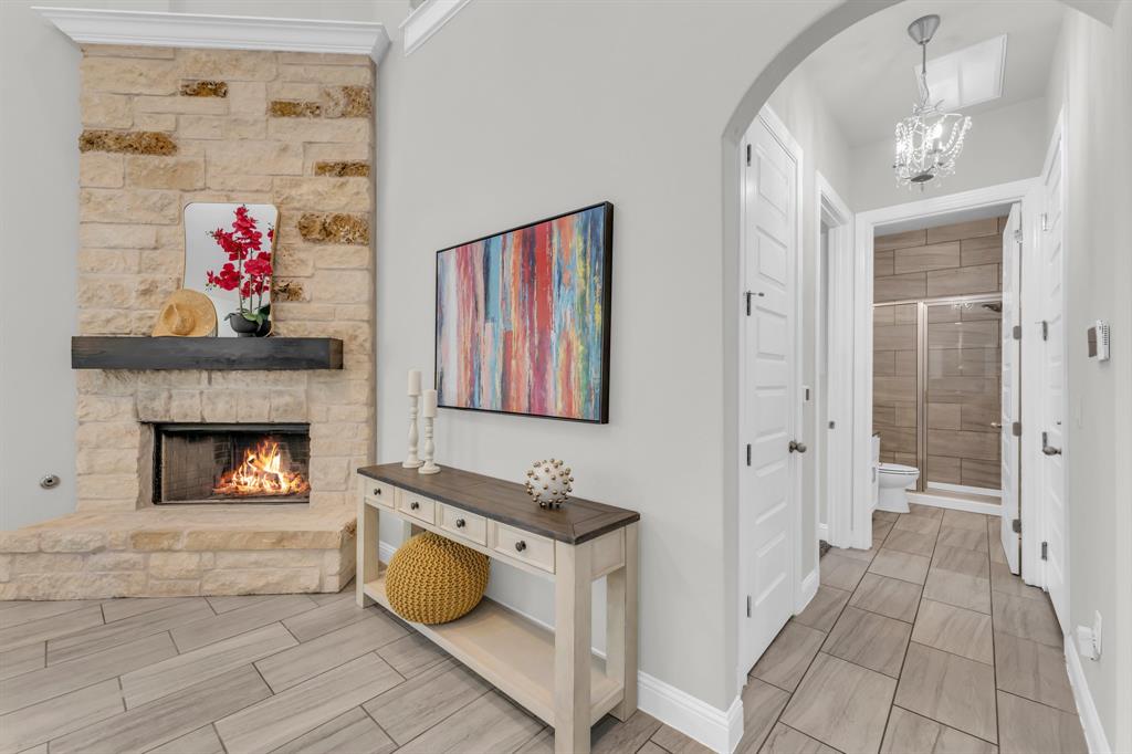 110 Magona Trail Georgetown, TX 78628 - Photo 17 of 38 A striking stone fireplace hearth and wood-look tiled floors define this inviting interior space.