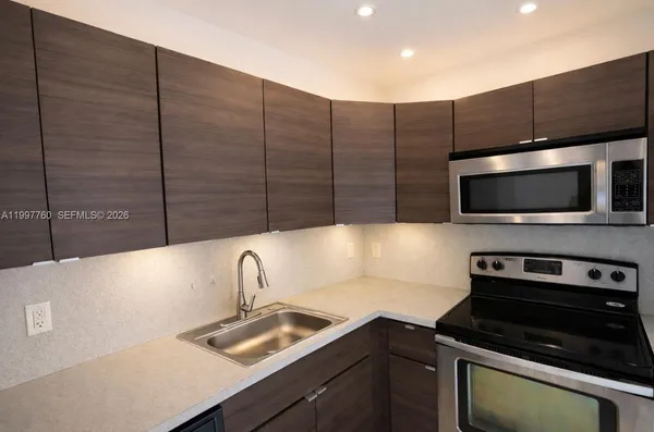 a kitchen with a sink and microwave