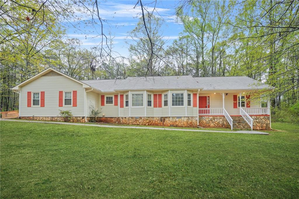 125 Bridget Drive Hampton, GA 30228 - Photo 1 of 32 a front view of a house with a yard and trees