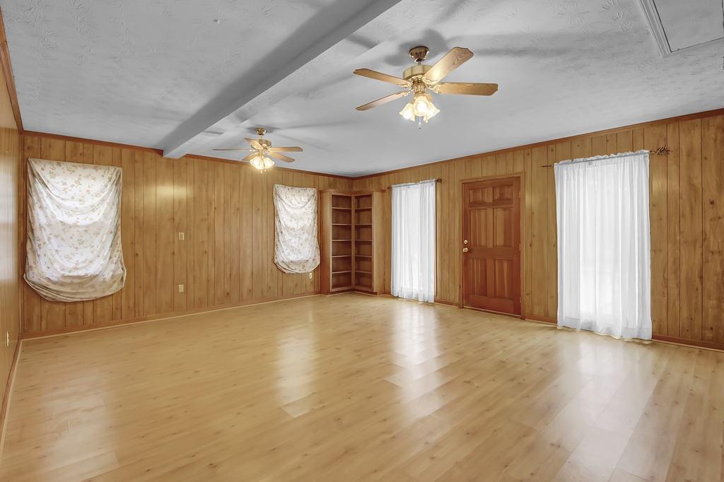 125 Bridget Drive Hampton, GA 30228 - Photo 13 of 32 an empty room with wooden floor and windows