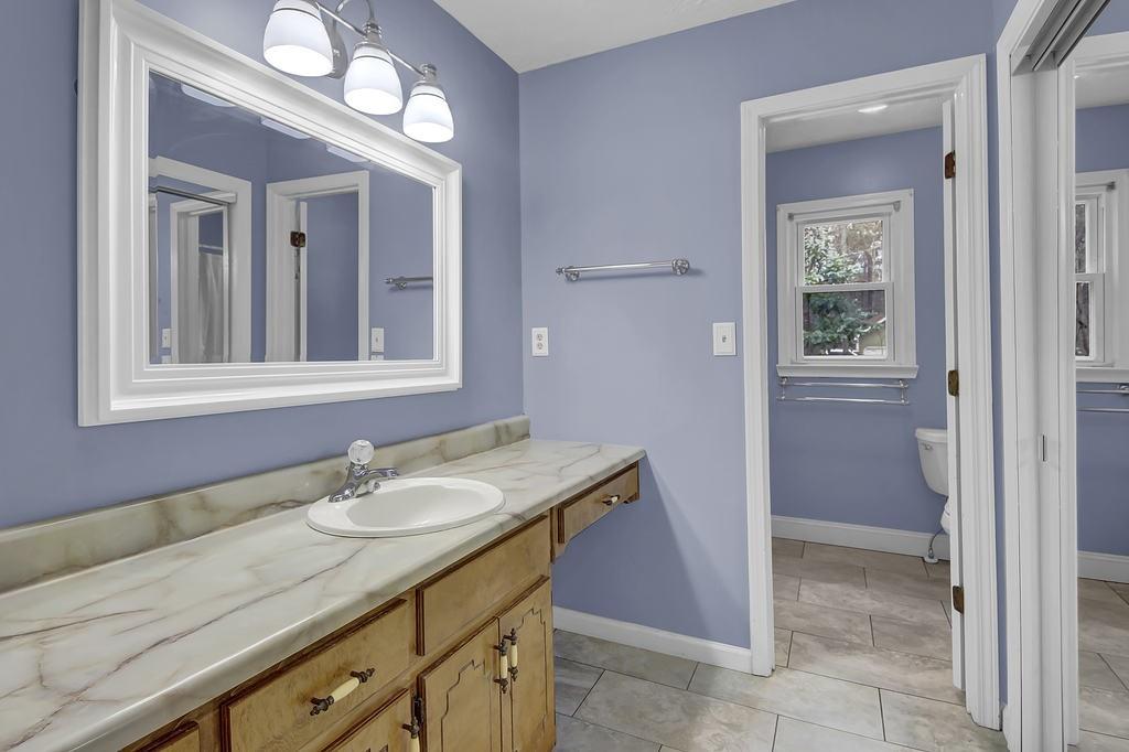 125 Bridget Drive Hampton, GA 30228 - Photo 16 of 32 a bathroom with a granite countertop sink and a mirror
