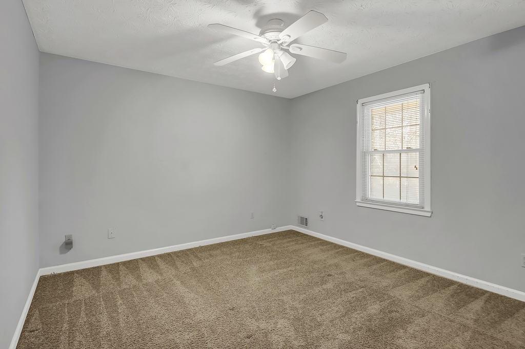 125 Bridget Drive Hampton, GA 30228 - Photo 19 of 32 an empty room with windows and fan